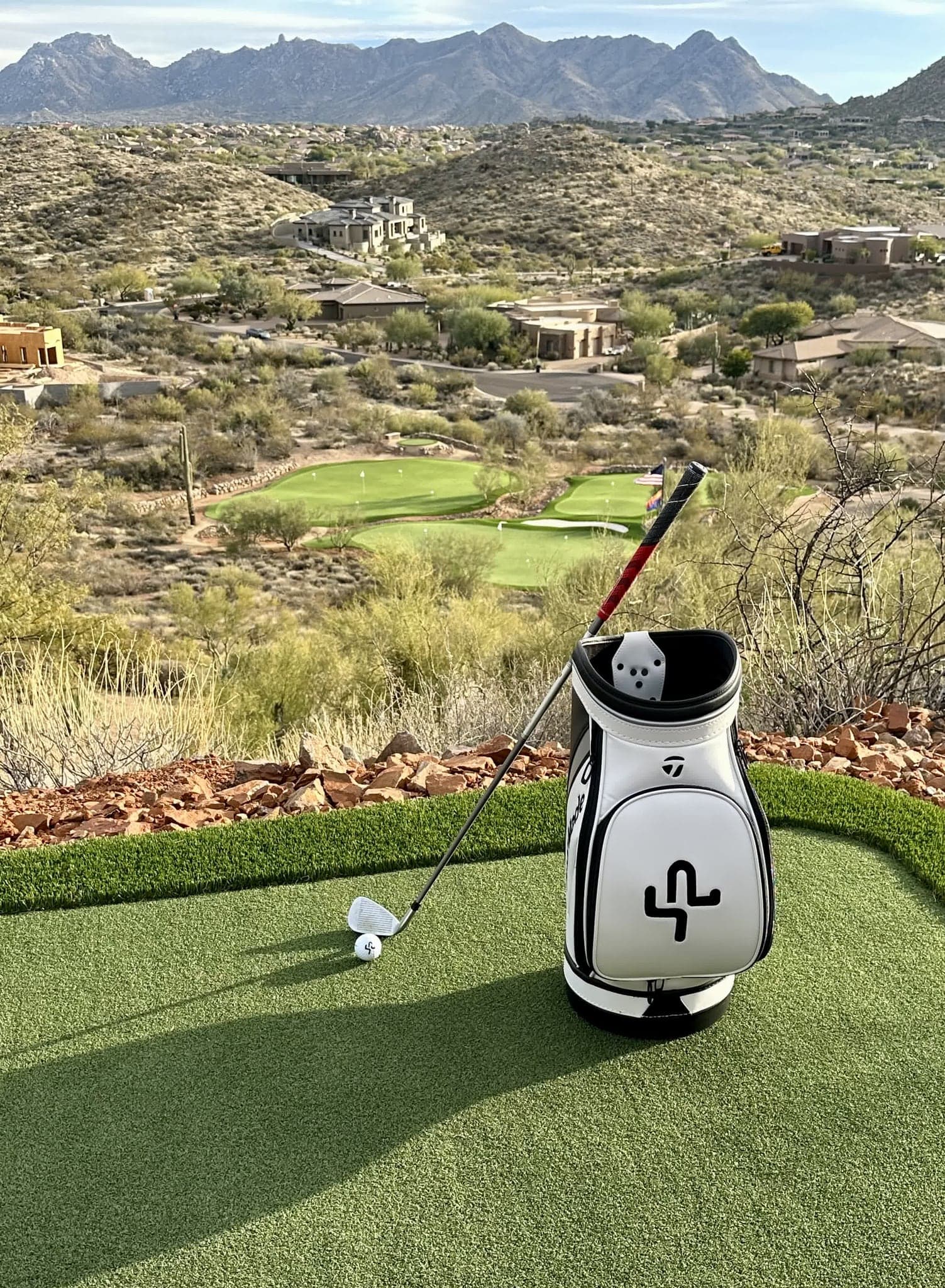 A Saguaro Point branded golf bag on the green at golden hour
