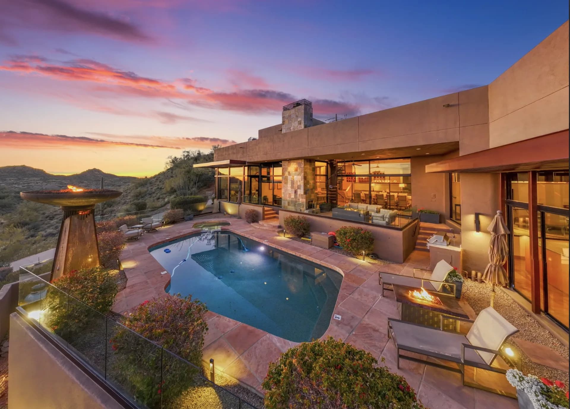 The pool, spa, and fire features glowing at sunset